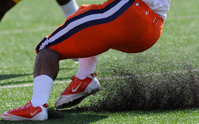 Football player running on synthetic turf field
